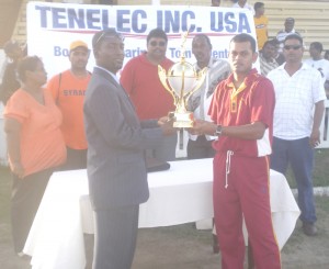 Albion skipper Orvin Mangru (right) collects the Tenelec Trophy from GCB’s Mark Lyght.