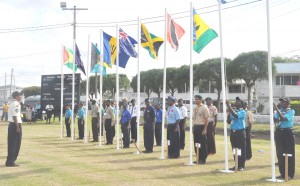 Scouts hoisting their respective flags.