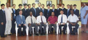 The volunteers (back row) pose with (sitting from left) General Secretary of Youth Volunteers Association of Nanjing, Ding Ming, Permanent Secretary within the Ministry of Foreign Affairs, Dr. John Isaacs, Chinese Ambassador to Guyana Zhang Jungao and Minister within the Ministry of Health Dr. Bheri Ramsaran. 