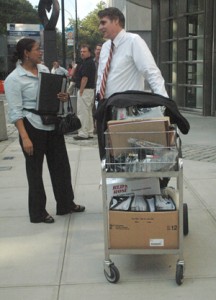 Julia Johnson and US Government Prosecuting Attorney, Daniel Brownell outside the NY Court with a cart of evidence used in the Simels/Irving case. (Marcel Leonard photo).