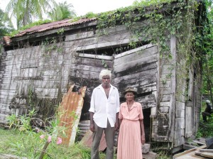 Gladys Madramootoo and her son David stand in front of the structure they home.