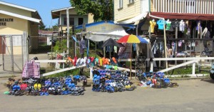 Slippers and other items marketed by the roadside vendors take up an ample portion of the Parika Public Road.