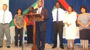 Flanked by several of his supporters, Opposition Leader Robert Corbin (at the podium) addresses the media