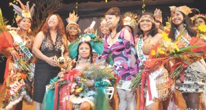 Amerindian Heritage Queen, Nadanie Jerry, is congratulated by Ministers Pauline Sukhai (on her right) and Desrey Fox (on her left), while being surrounded by the other contestants.