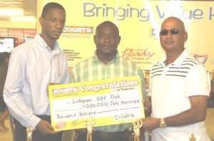 Courts Marketing Assistant Pernell Cummings (left)  presents the cheque to Jerome Khan, captain of Lusignan Golf Club (right) while Troy Peters, Public Relations Officer of the LGC looks on.