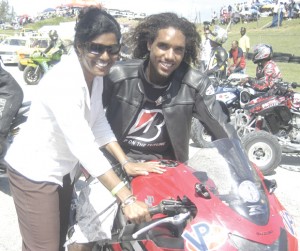 Barbados’ Sports Minister Dr. Esther Byer-Suckhoo about to get a ride on Brook Miller’s Ducati 1098 to signal the Lap of Honour last Sunday.