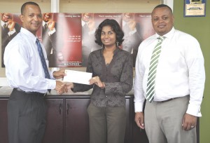 Ansa McAl Trading Public Relations Officer Darshanie Yussuf (centre) hands over cheque to EDFA President Aubrey Hutson; at right is Marketing Director, Troy Cadogan. 