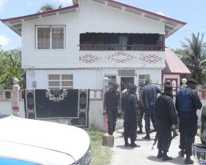  Ranks from the police anti-crime squad gather  outside the yard where the gunman was spotted. 