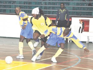 Alpha Sylvester of Alpha United (centre) works his way successfully between two Victoria Kings defenders in their game which the former won, 4-0. (Franklin Wilson photo)