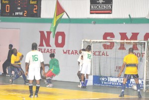 Devon Millington (left) beats the Northern Rangers goalkeeper and their 3-man wall from an acute angle to score Western Tigers’ third goal on Saturday night. (Franklin Wilson photo) 