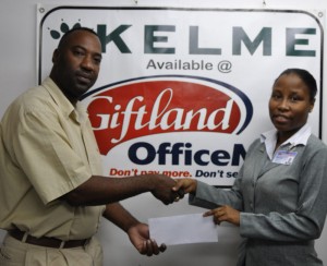  Giftland Office Max Personnel Officer Wonita Joseph  (right) hands over the cheque to Frank ‘English’ Parris.