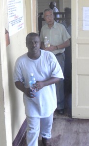 Clairmonte Marcus (foreground) and Dr. Walter Ramsahoye at the court house yesterday