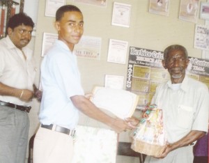 One of the workers receives his award from BCB’s Malcolm Peters (right).