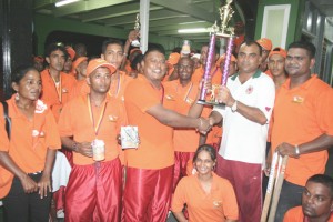 Skipper Ramdeo Parmeshwar receives Nand Persaud Memorial trophy from loosing Captain Ricky Deonarain (right).
