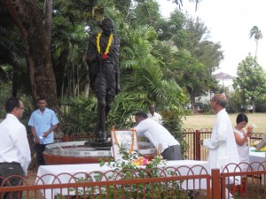 Prime Minister Hinds places a floral offering at Gandhi’s statue