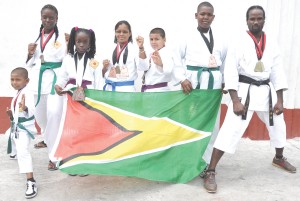The successful seven-member Karate team displaying their medals won in Trinidad. From left Lazaro Scott, Nicola Mc Donald, Tamera Austin, Teri Jones, Romeo De Freitas, Kemo Scott and Troy Bobb.