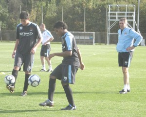 Manchester City Academy Coach, Paul Power, watches Alex Gutierrez from Honduras and Julio Segundo from Panama controlling the ball during training. 
