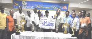 Managing Director NAMILCO Bert Sukhai (4th right) presents the cheque to Fruta Conquerors President (Ag) Ivor Thompson at the tournament launch.