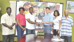 Stag Beer Brand Manager John Maikoo (3rd right) hands over the cheque to Franklin Wilson (GFF 2nd VP). others in photo from left, Clive Matthews (EBFA VP), Icenie Inniss (EBFA Sect), Darshanie Yussuf (PRO Ansa McAl) and Noel Harry (EBFA Trea.)