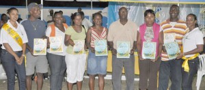 Members of the Fruta conquerors Executive flanked by two members of NAMILCO display their Certificates of Dedication following the presentation at the Tucville ground. From 2nd left are Lester Peters, Doris Leonard, Margret Shultz, Lavern Fraser-Thomas, Ivor Thompson, Candia Shepherd and Wayne St. Jules.