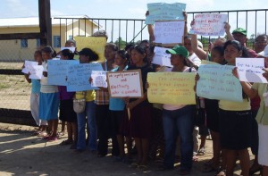 Parents and teachers of St. Ignatius Primary School  block the gate of the school during the protest.