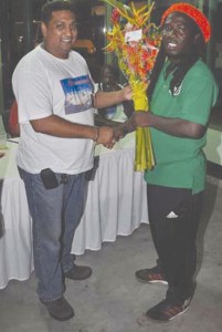Suriname Independence Cup, Tournament Manager,  Aniel Ghisaidoobe left presenting Wayne Dover  with a bouquet of flowers on his birthday.