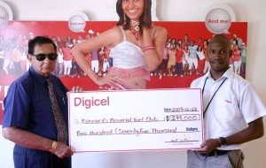 Digicel's Sales Manager Dwayne Scott (right) hands over the sponsorship cheque to Justice Cecil Kennard yesterday.