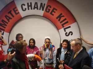 Former President of Ireland Mary Robinson, left, talks with UN climate chief Yvo de Boer, right, in front a three metre-high lifebelt emblazoned with the message “Climate Change Kills.” 