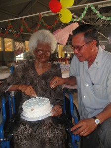Aunty Millicent Sealy shares her 103 birthday cake with Reverend Lesley Edmondson