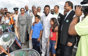 The 'King of football' flanked by two young fans, enjoys steel pan music on his arrival in Guyana.  Several football officials including GFF boss Colin Klass (to Pele's right) and Kashif Muhammad (to Pele's left) and Sports Minister Dr. Frank Anthony (right) were part of the welcoming party.