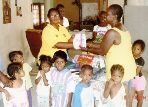  BCB Secretary Angela Haniff (left) handing over one  of the Hygienic Kits to Pansy Howell Fedee in the presence  of inmates of the Children of Promise Eden Orphanage.