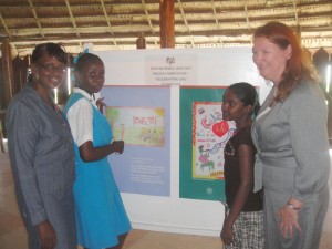 Chief-Education Officer (ag) Genevieve Whyte Nedd at left is  in the company of US Charge’d’ Affaires Karen Williams with  Athaliah Lambert of St. Gabriel’s Primary School and Mariea  Harrinarine of Patentia Secondary School.