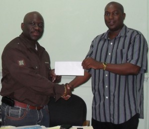 DONE DEAL:  An elated Bristol (left) hands over the  cheque to GABA boss, Steve Ninvalle yesterday morning.