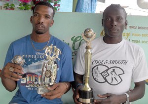 Captain of the Pele FC Dillon Fraser  (left) and goalkeeper Derrick Carter show  off some of their winnings in the recently concluded K&S Football extravaganza.