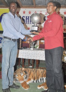 Tournament MVP Derrick Carter  receiving his trophy from Kashif Muhammad. 