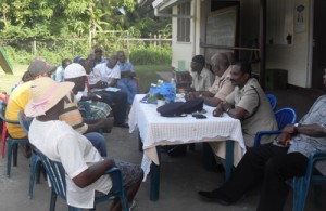 Senior officials from the Police East Coast Division interact with members of the golden grove community yesterday.