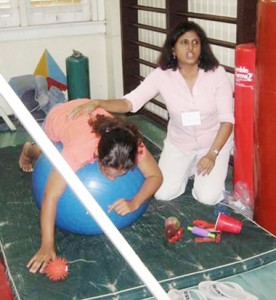 Revathi Narayanan, Psychologist and Sensory Integration Therapist in training with an Autistic child. 