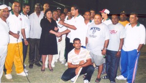 Ray Seebarran (right centre) hands over cheque to  Priya Manickchand on behalf of Floodlights