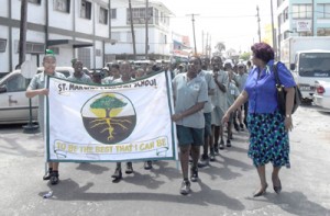 The students of St Margaret’s Primary school, led by one of their teachers, march through the streets of central Georgetown shortly after attending a church service at the St Andrew's Kirk’s Anglican Church, Stabroek 