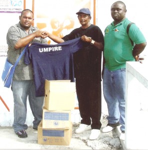 NUNV Volunteer Moonish Singh (left) hands over one of the Polo shirts to ECUA President Zaheer Zakier. 