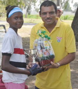 Well Done!!! Crystal Blackman (left) collects her hamper from Financial Director Shahzar Ali.