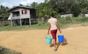 A resident fetching water to her home