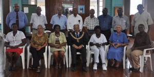 Freemasons’ District Grand Master, Bro. Richard B. Fields (seated, centre) is flanked by several representatives of the charitable organisations that received cash donations from the District Grand Lodge of Freemasons in Guyana, yesterday, while Lodge members stand behind.