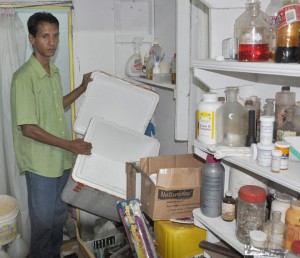 Ram’s Pharmacy owner Lakeram Odit holds  up one of the canisters that was emptied by the bandits. 