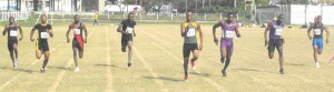 IMPECCABLE DOMINANCE!! Chavez Ageday (centre) leaves no stones unturned as he powers his way to the CARIFTA Games qualifying time and his personal best in the U-20 Boys 100m at the Police Sports Club Ground yesterday.