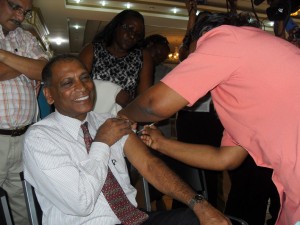 A smiling Dr Leslie Ramsammy gets his H1N1 vaccine