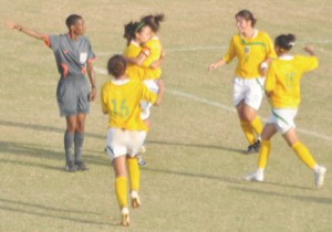 Lady Jags Captain Ashley Rodrigues is the first to congratulate Alison Heydorn after her goal against the SVG which sealed Guyana's triumph in group A of the CFU World Cup qualification campaign.