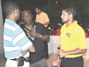 Guyana Skipper Ramnaresh Sarwan chat with Windwards Manager Lockhart Sebastian and a member of the Guyana, Grenada Friendship Association during Saturday night’s function for the 2 teams in Grenada. 