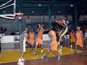 THIS WAS NOT ENOUGH!!! Akeem ‘The Dream’ Kanhai (airborne with ball) has the full compliment of five East Coast defenders, with Horace Hodges (second left in the paint), setting up the wall. But that was not enough to stop Kanhai.
