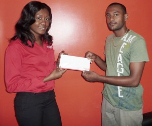 Digicel’s Shonette Moore (left) handsover the sponsorship cheque to SASS Executive Sameer Bacchus.  